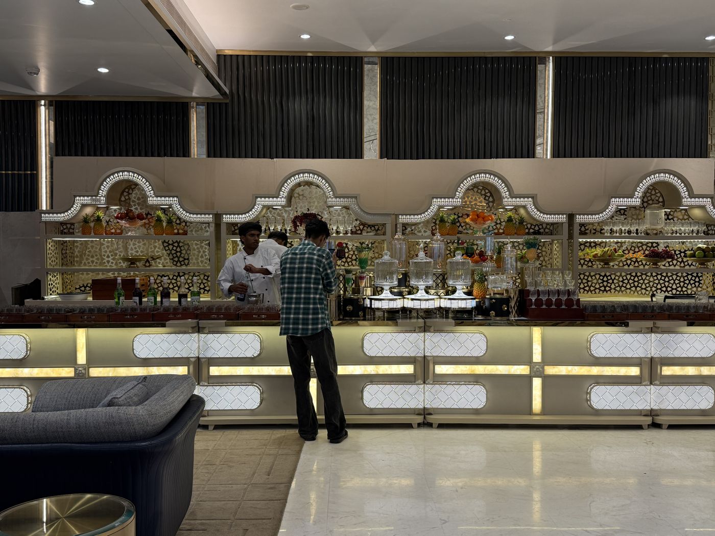 A long lit buffet counter in an empty hall before guests arrive