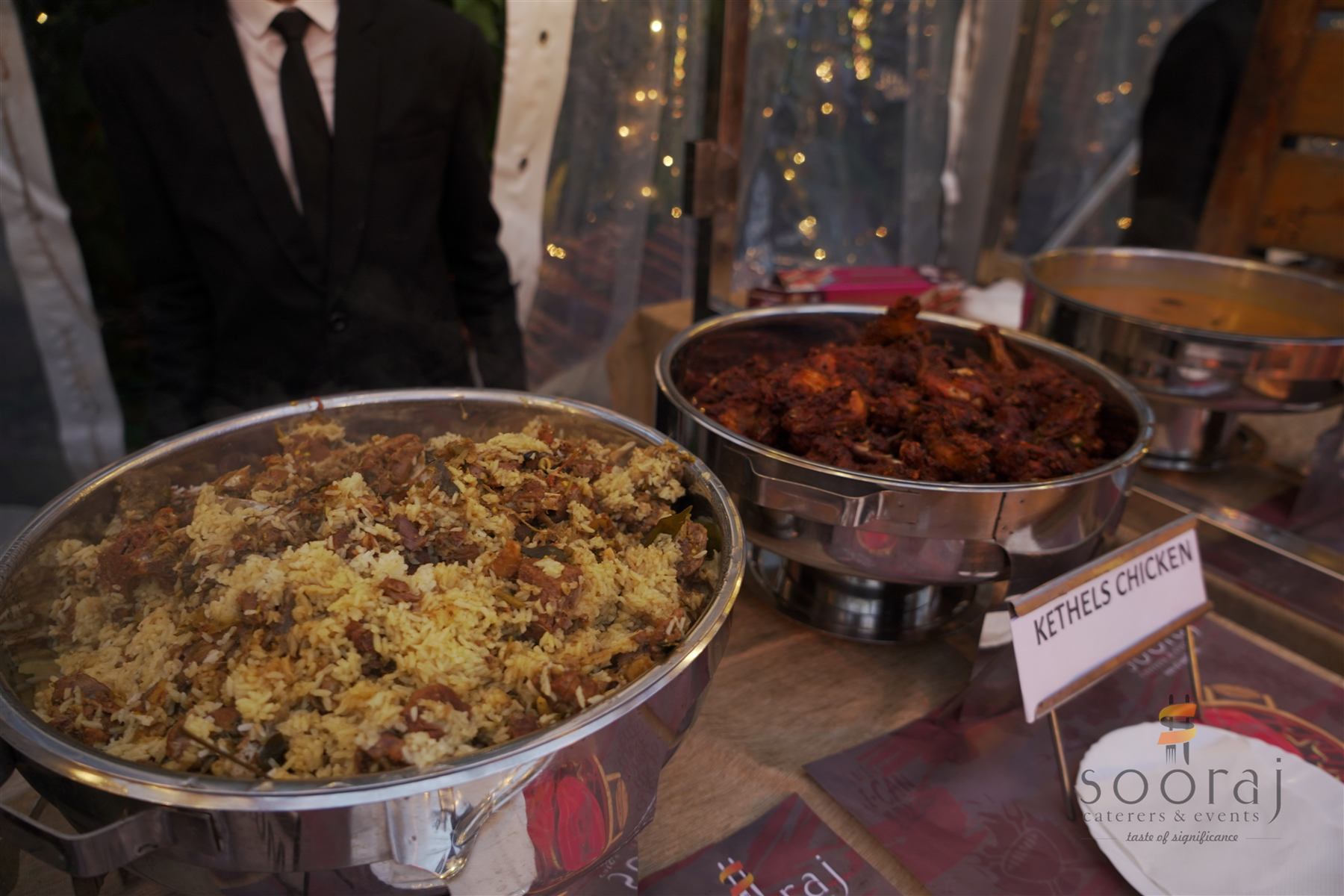 Buffet trays of biryani and chicken curry